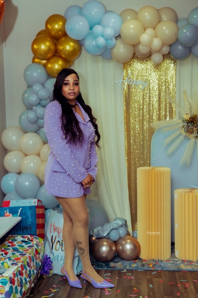 Birthday celebration and glamour event portrait with balloon arch and shimmering backdrop